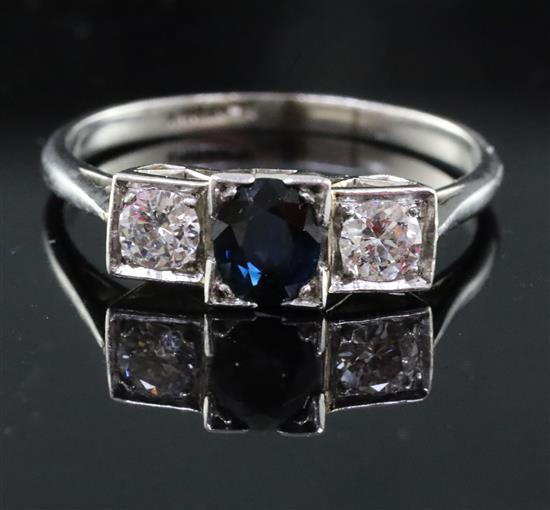 A 1930s platinum, sapphire and diamond three stone ring, size R.